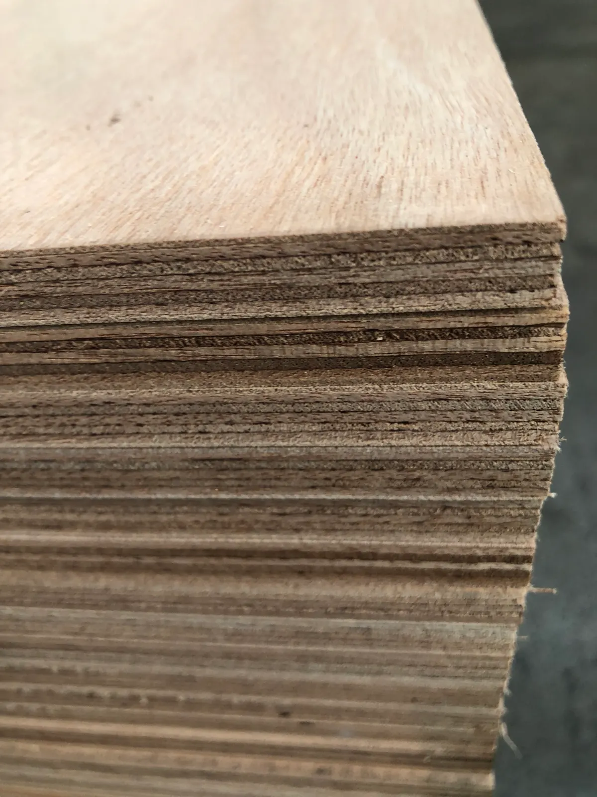 Stacked Okoume marine plywood sheet edges
