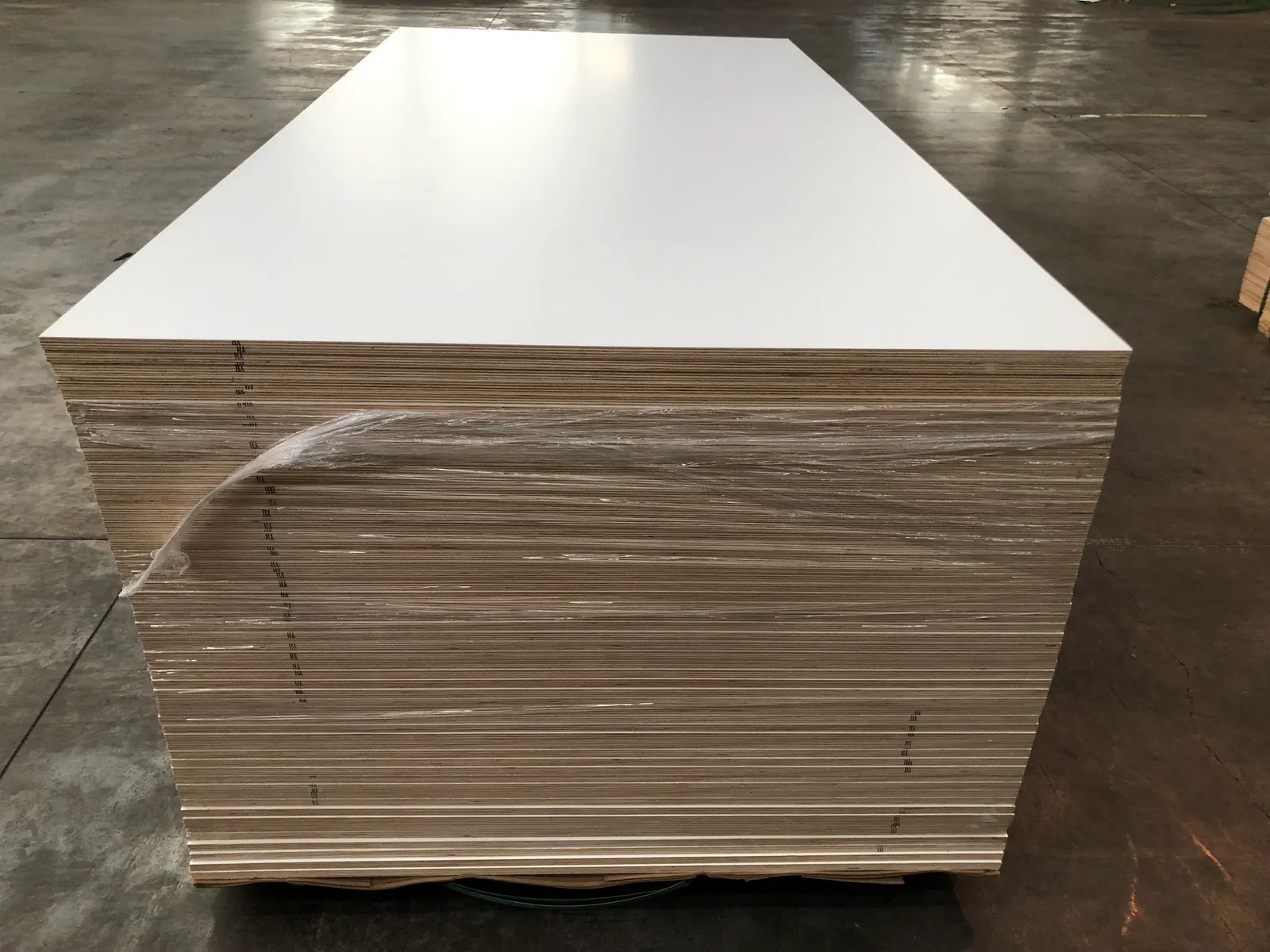 Pallet stack of white melamine plywood sheets